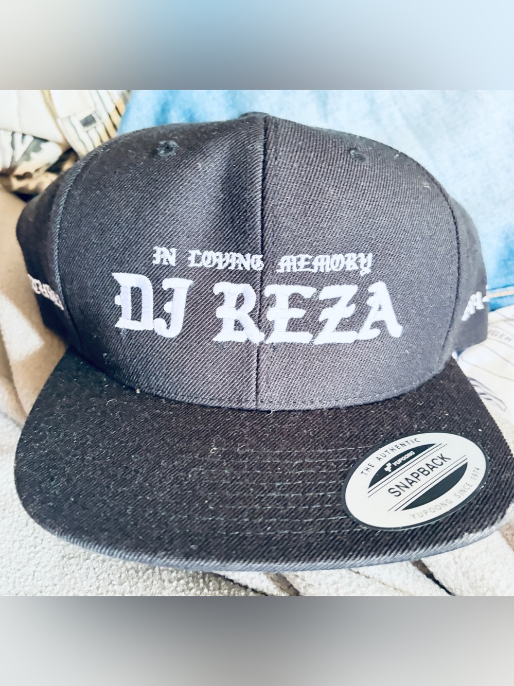 The Classic Black Snapback Hat with White "DJ REZA" Embroidery